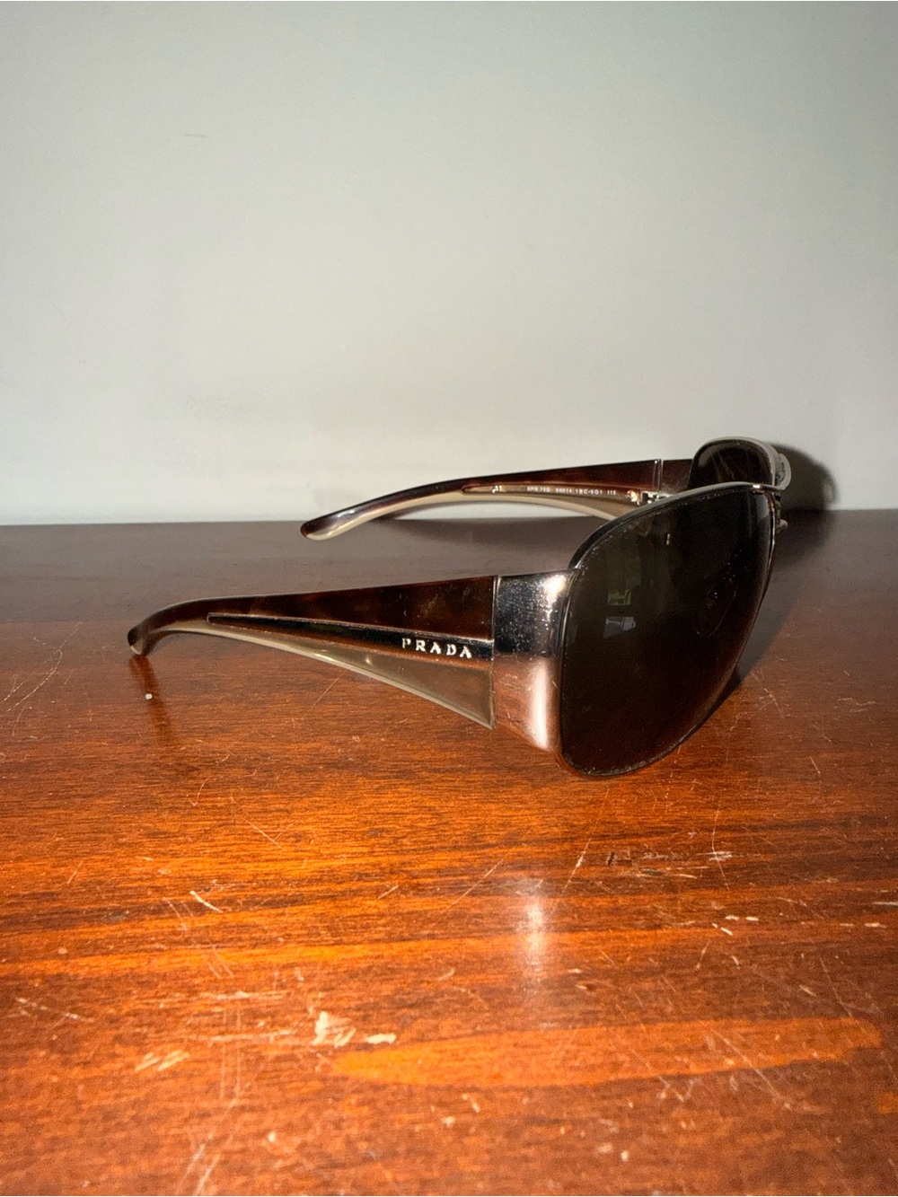Prada SPR75G Aviator silver frame sunglasses. Tortoise and clear color on side